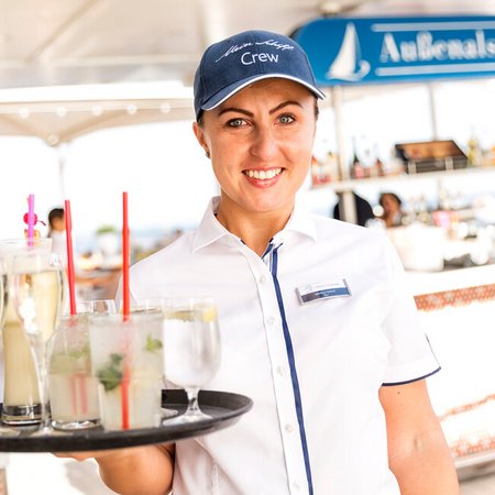 Barkeeper auf Mein Schiff serviert Drinks an der Bar "Außenalster"